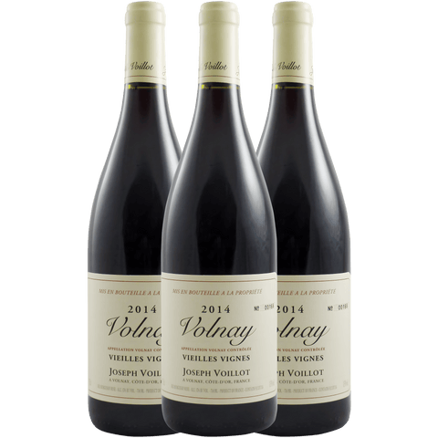 Three bottles of 2014 Volnay wine from Joseph Voillot on a green background